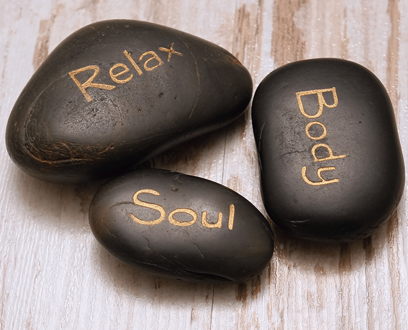 Massage stones engraved with Relax, Body and Soul